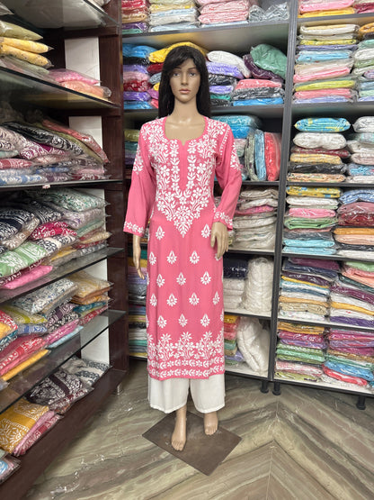 Mannequin wearing a pink embroidered outfit in a fabric store