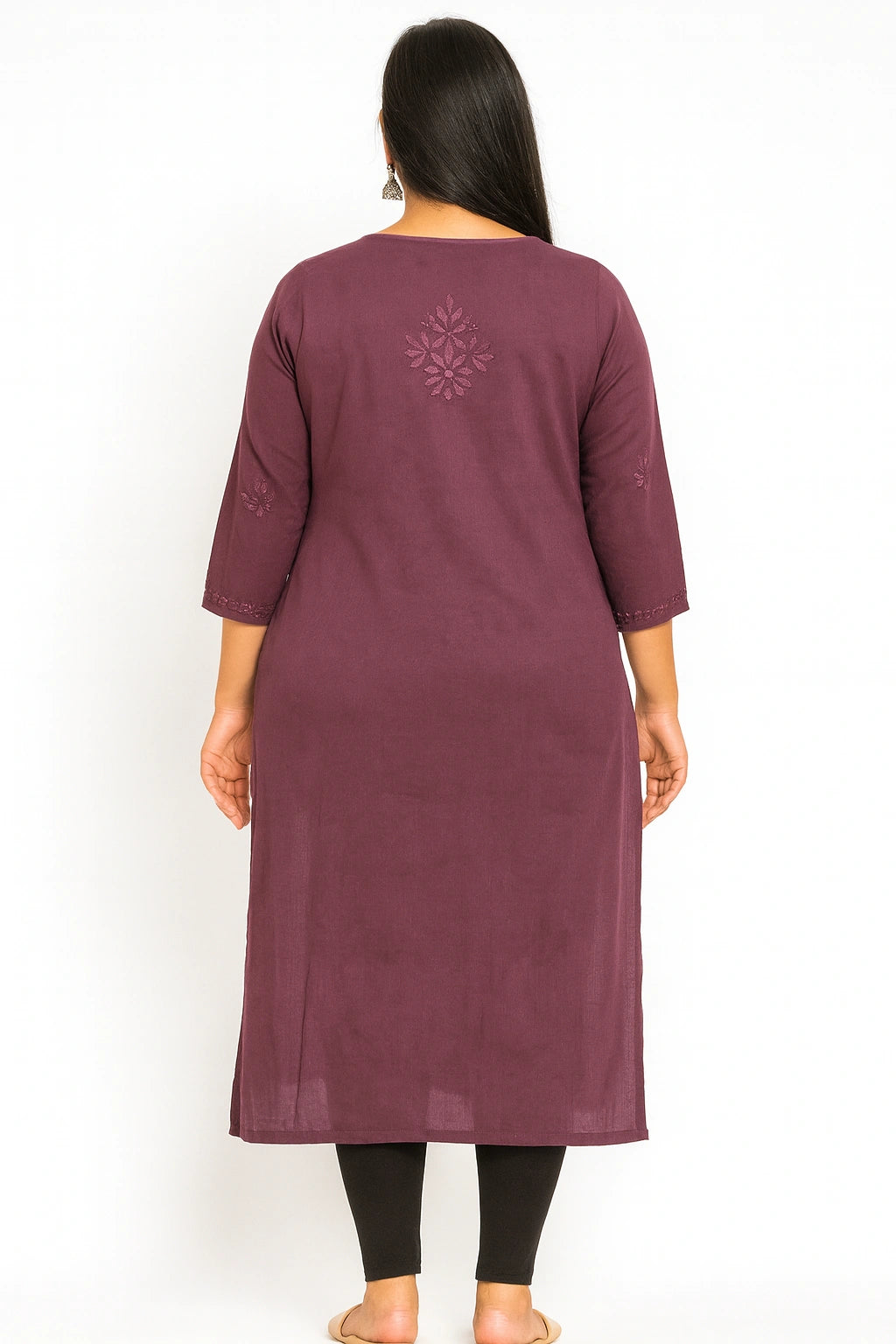 Woman wearing a lucknowi chikankari maroon kurta with a snowflake design on a white background