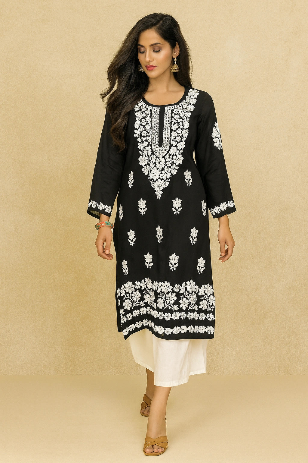 Woman wearing a black and white embroidered kurta against a beige background