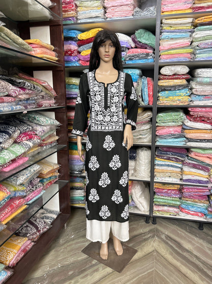 Lucknowi chikankari Mannequin wearing a black and white patterned dress in a fabric store.