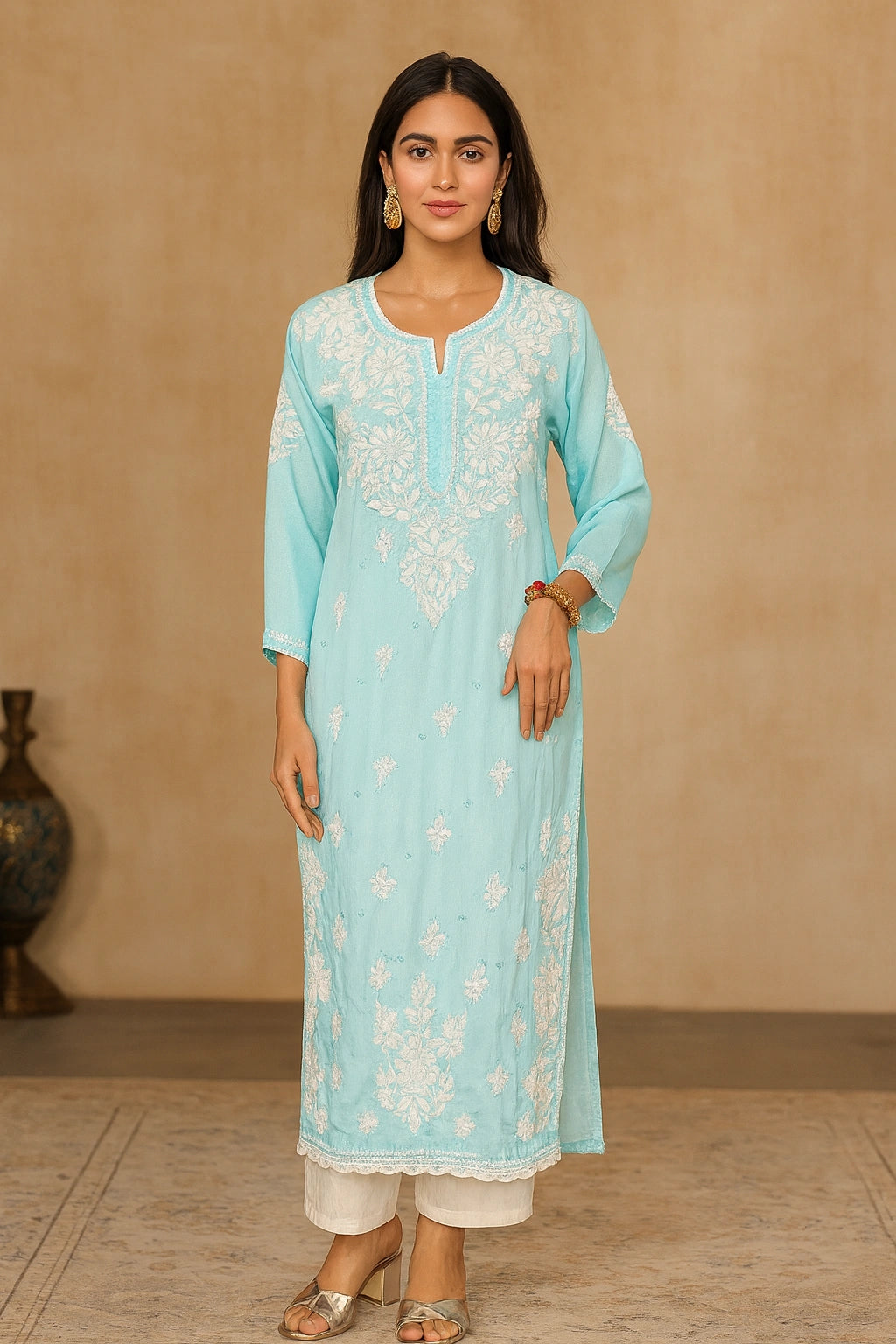 lucknowi chikankari Woman wearing a light blue kurta with white floral patterns against a beige background