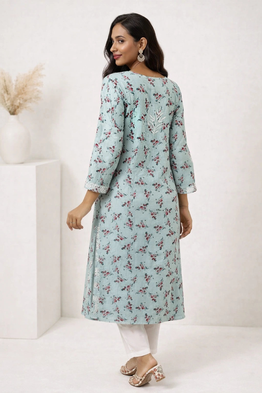 lucknowi chikankari Woman wearing a light blue floral dress against a white background
