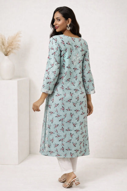 lucknowi chikankari Woman wearing a light blue floral dress against a white background