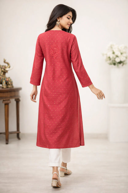 lucknowi chikankari Woman wearing a red kurta with white pants in a minimalistic setting