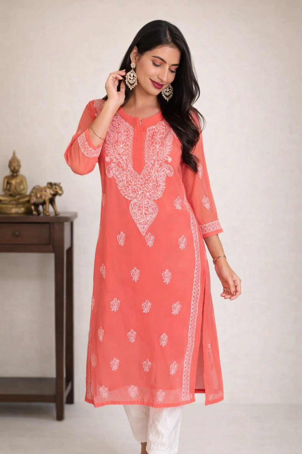 lucknowi chikankari Woman wearing a red kurta with white pants against a white background