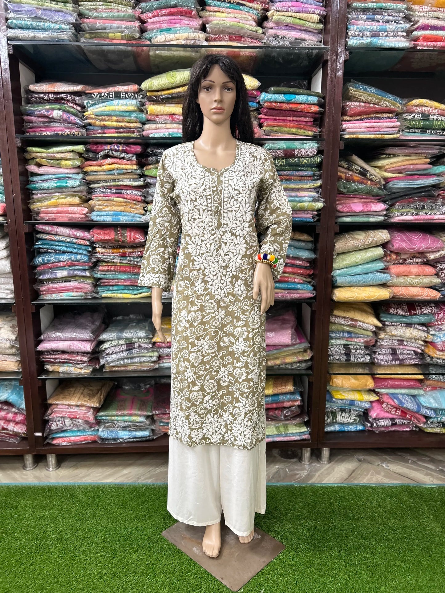 lucknowi chikankari Mannequin wearing a patterned kurta with a colorful fabric background