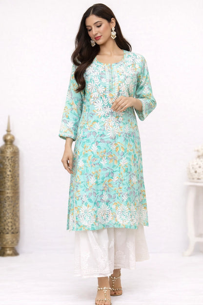 Woman wearing a lucknowi chikankari light blue floral kurta with white pants on a white background
