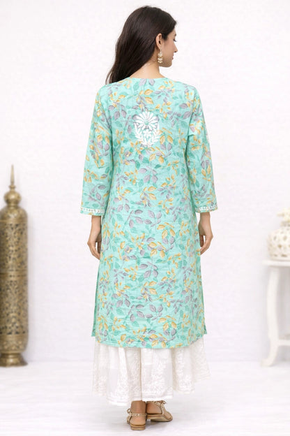 Woman wearing a lucknowi chikankari light blue floral kurta with white pants on a white background