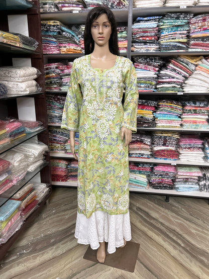 Mannequin wearing a lucknowi chikankari green floral dress in a fabric store