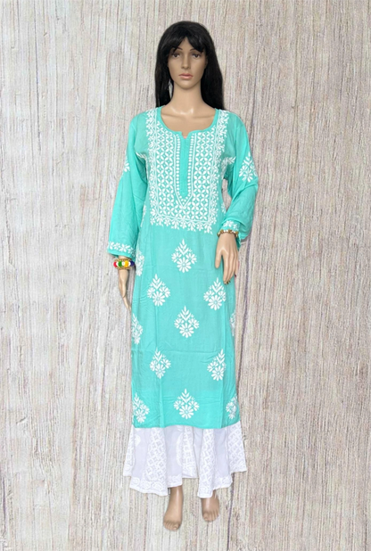 Turquoise and white embroidered dress on a wooden background