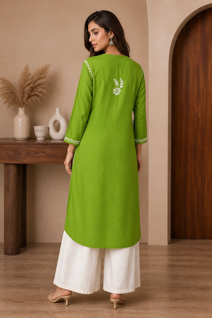 Woman wearing a lucknowi chikankari light blue floral kurta with white pants on a white background