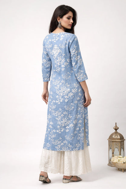 Woman wearing a lucknowi chikankari blue floral kurta with white pants on a white background