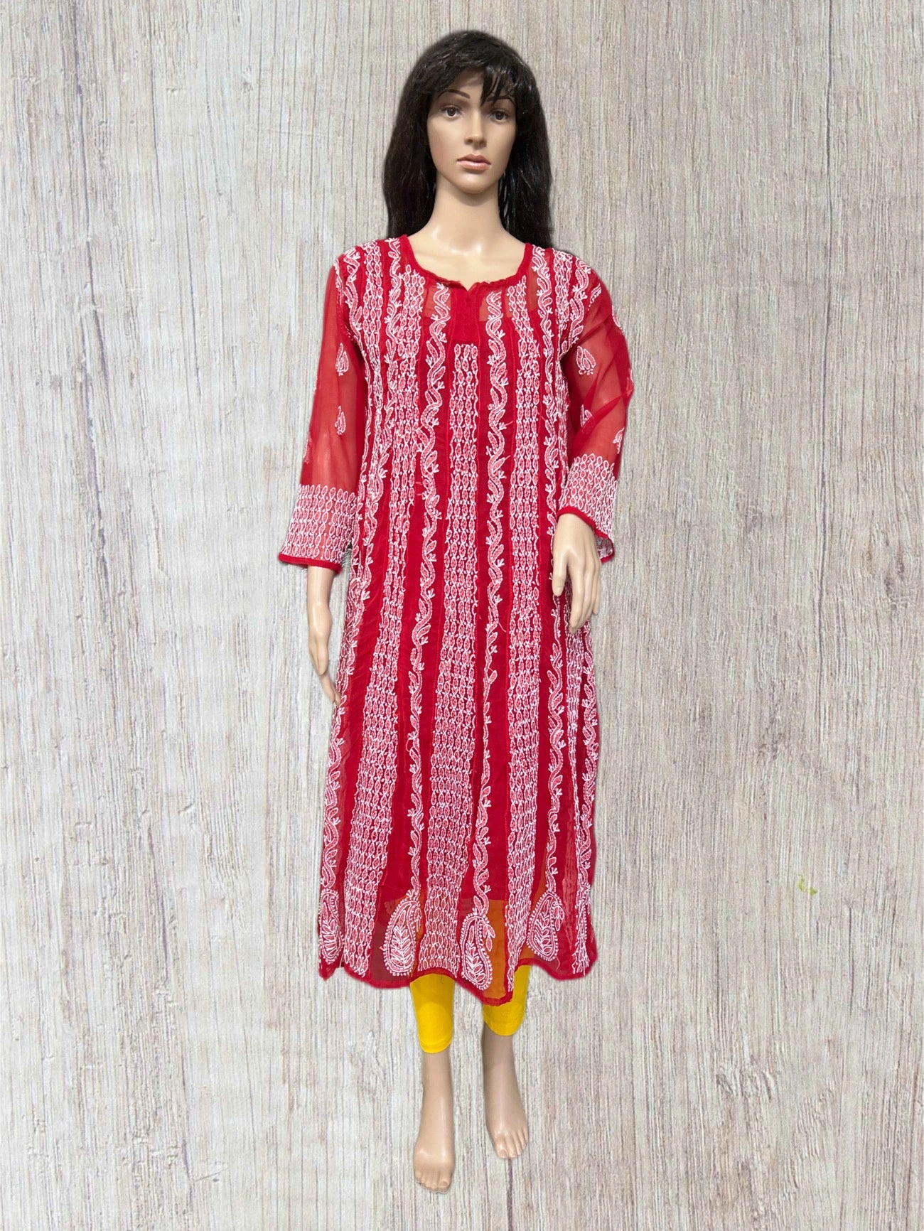 lucknowi chikankari Red and white patterned kurta on a mannequin against a wooden background