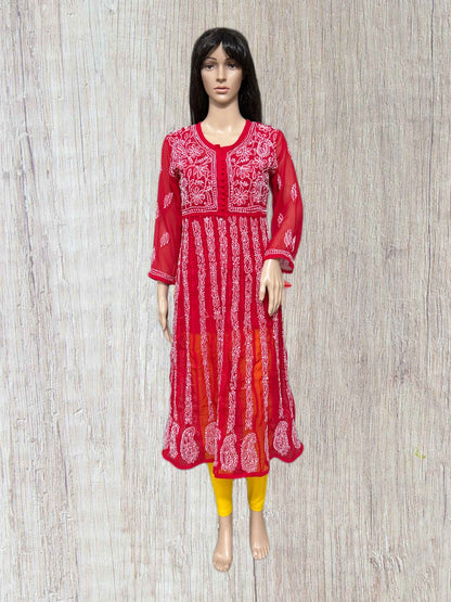 lucknowi chikankari Red and white patterned dress on a mannequin against a wooden panel background