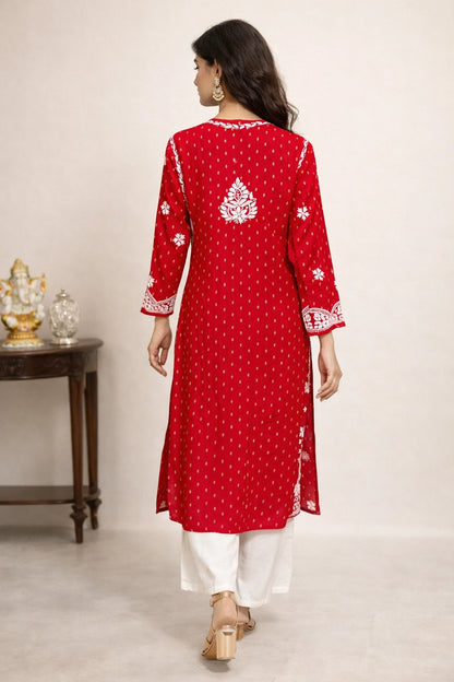 lucknowi chikankari Woman wearing a red embroidered kurta with white pants on a plain background