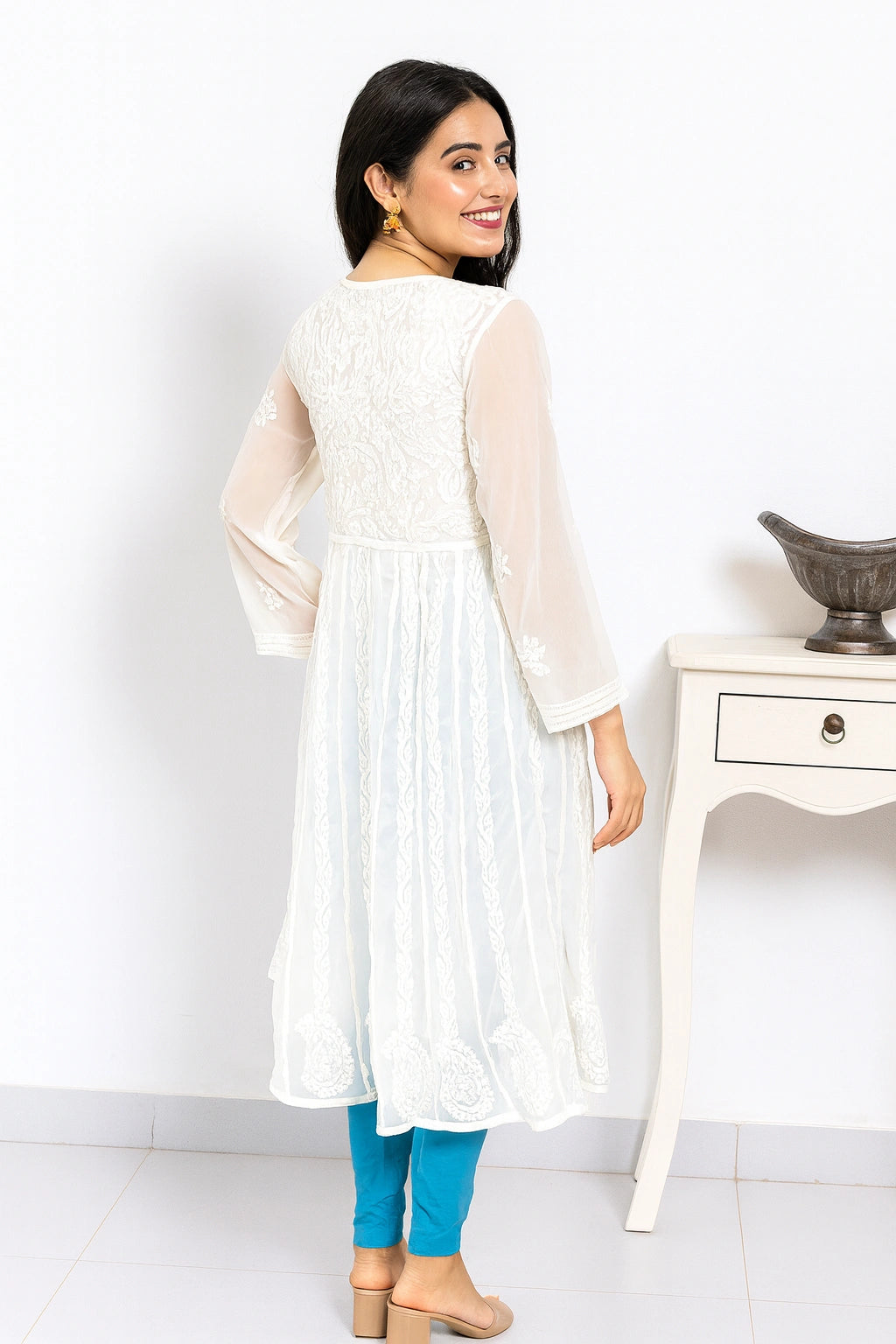 lucknowi chikankari Woman wearing a white kurta with blue pants against a white background