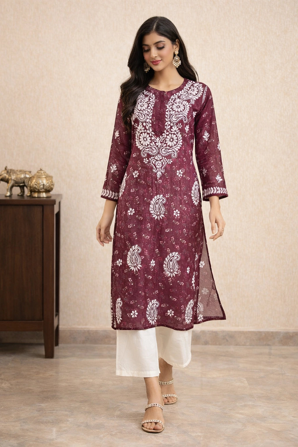 lucknowi chikankari Woman wearing a maroon kurta with white patterns in a room setting.
