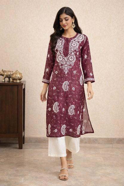 lucknowi chikankari Woman wearing a maroon kurta with white patterns in a room setting.
