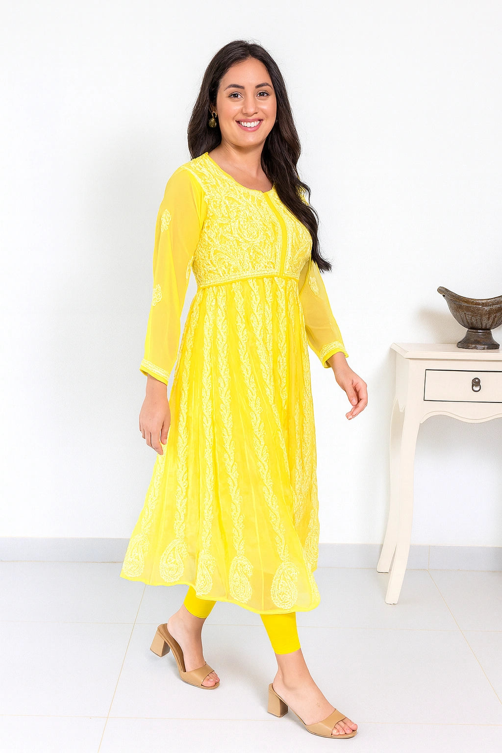 lucknowi chikankari Woman wearing a yellow dress with a white background