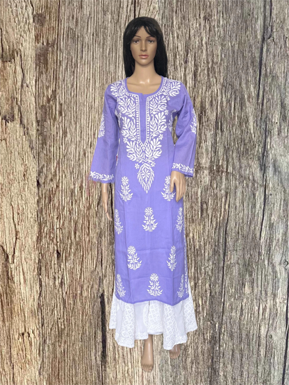 A purple long kurta dress with white floral embroidery and a white lace hem, displayed on a mannequin against a rustic wood plank background.