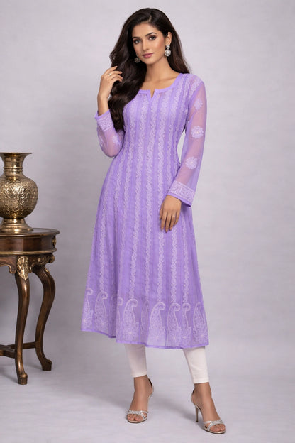 Woman wearing a light purple kurta with white pants against a gray background