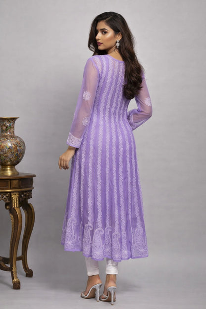 Woman wearing a purple embroidered dress with a gray background