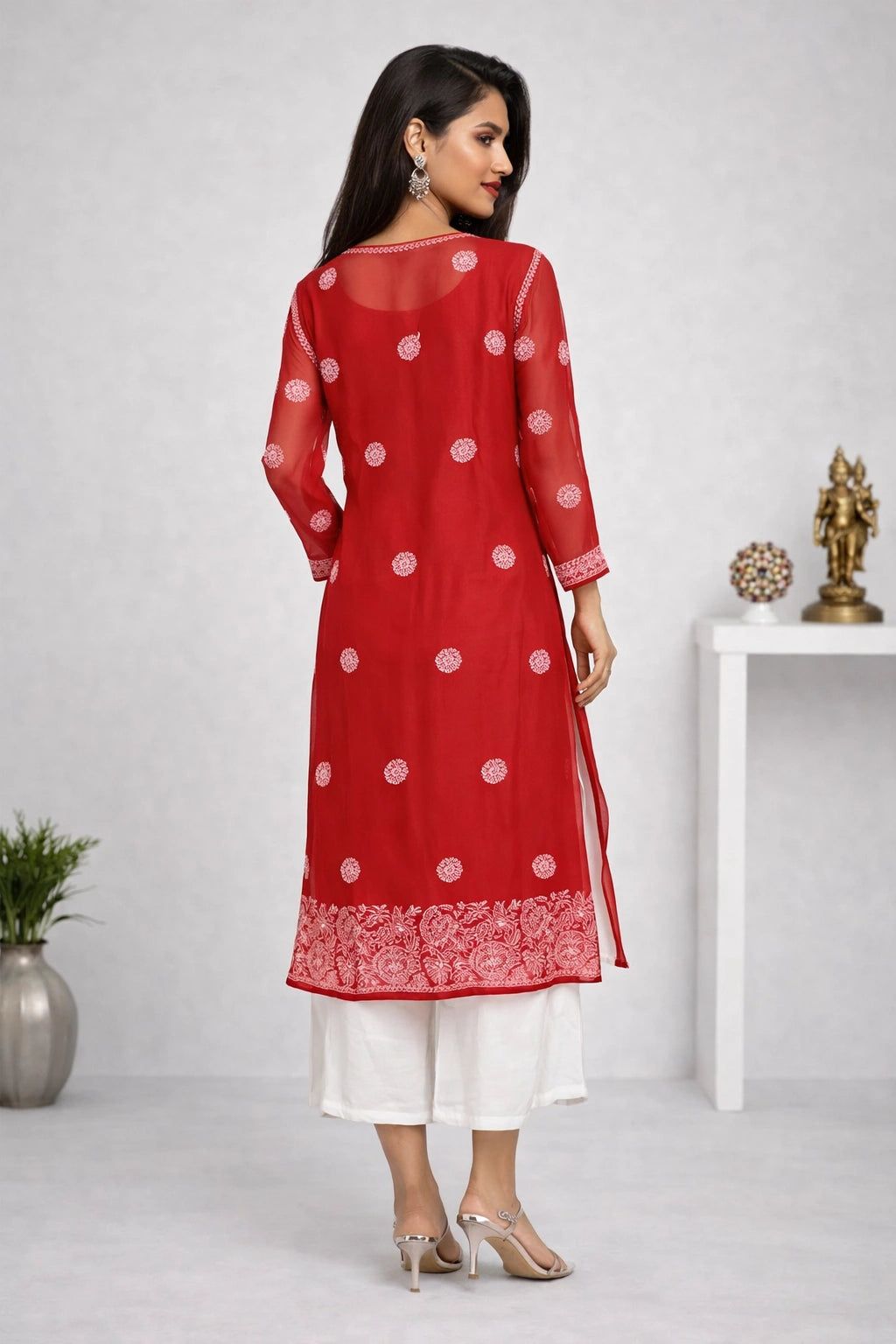 Woman wearing a red and white traditional outfit with a white background