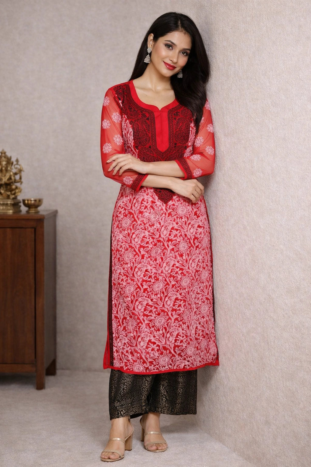 Woman wearing a pink and white lucknowi chikankari traditional outfit with a neutral background