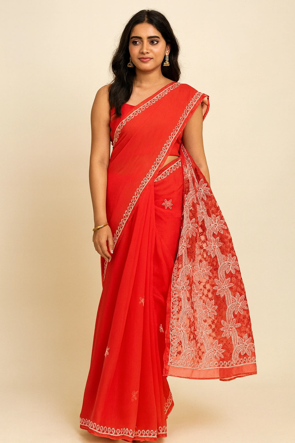 Woman wearing a red saree with white embroidery on a beige background