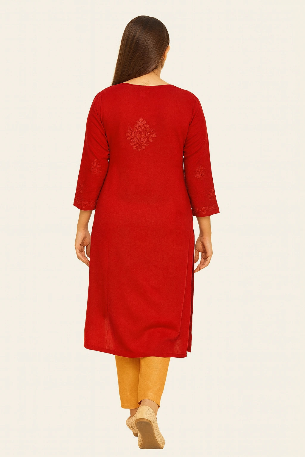 Woman wearing a lucknowi chikankari red kurta with yellow pants on a white background