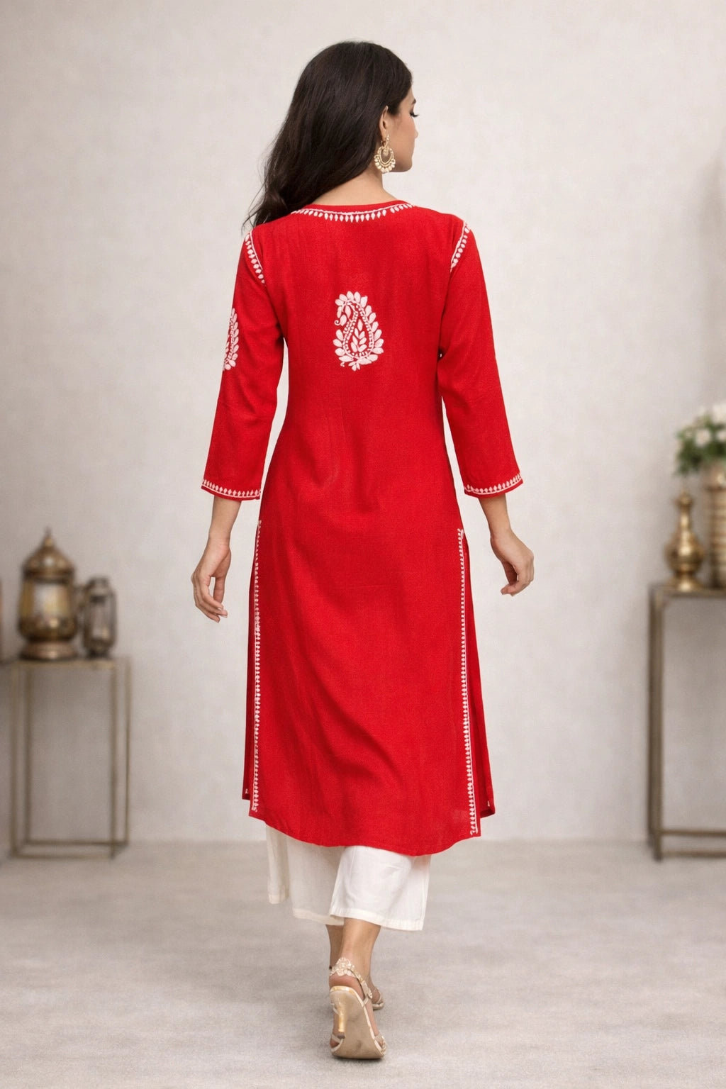 Lucknowi Chikankari Woman wearing a red kurta with white patterns in a minimalistic setting