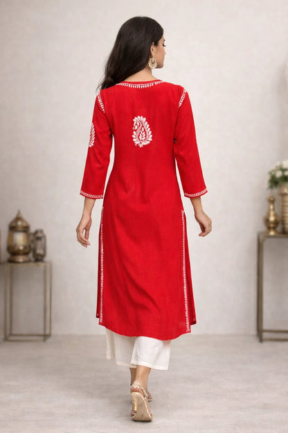 Lucknowi Chikankari Woman wearing a red kurta with white patterns in a minimalistic setting