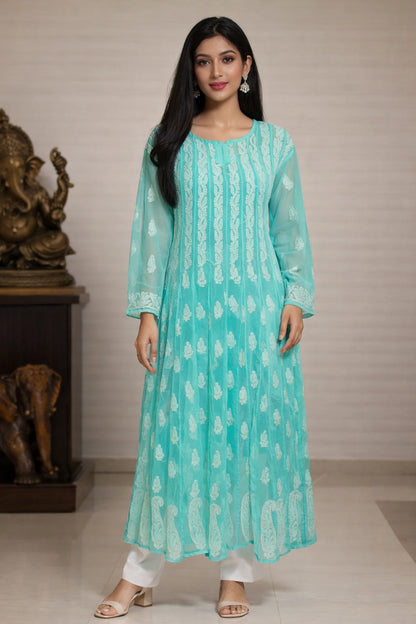 Woman wearing a light blue kurta with white patterns in a neutral setting.