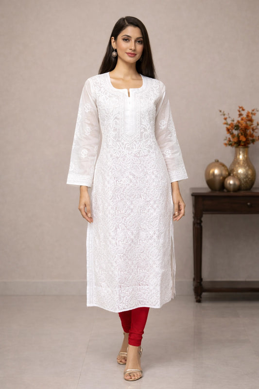 Woman wearing a white kurta with red pants in a minimalistic setting