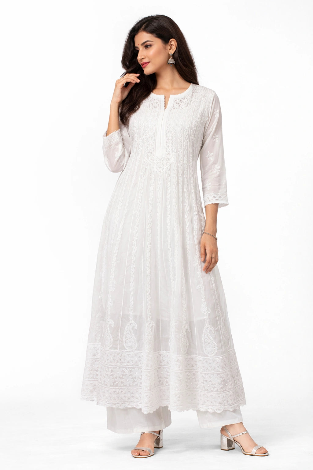 Woman wearing a white long dress with a subtle pattern on a white background