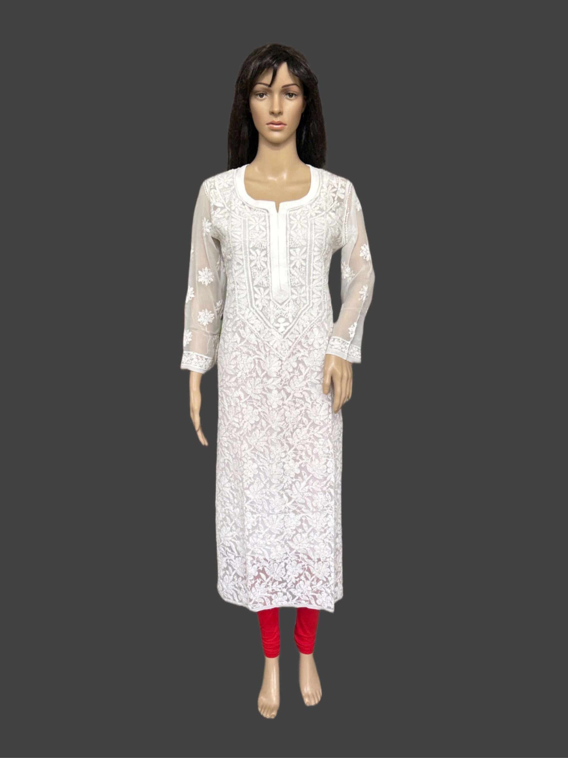 White embroidered kurta with red pants on a mannequin against a gray background