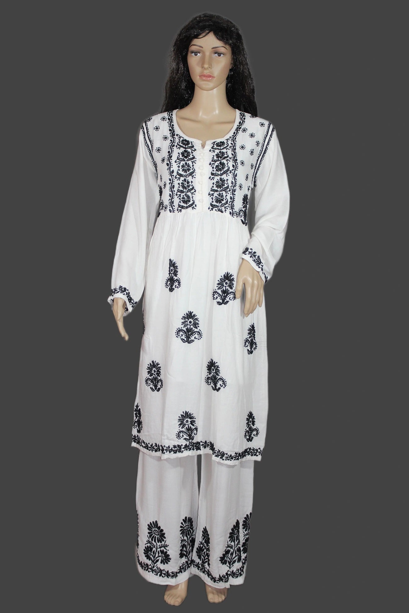 White outfit with black floral patterns on a gray background