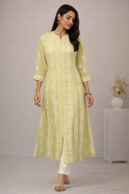 Woman wearing a light green kurta with white pants against a plain background