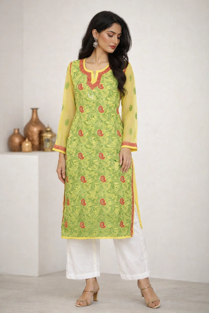 Woman wearing a lucknowi chikan green and yellow traditional outfit with white pants against a white background