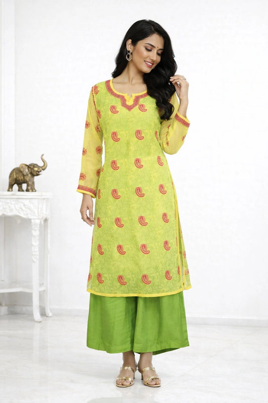 Woman wearing a green and yellow traditional outfit with red patterns on a white background