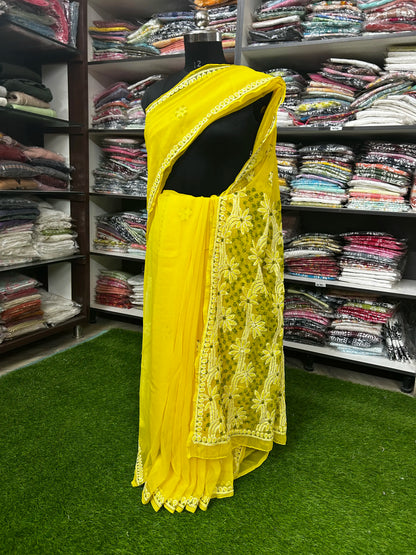 Lucknowi chikankari Yellow saree with lace details on a mannequin in a clothing store.