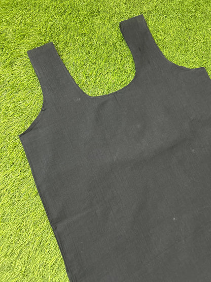 A black slip laid flat on bright green artificial grass.