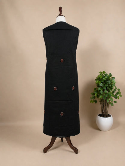 Lucknowi chikankari Black dress on a mannequin with decorative buttons against a beige background