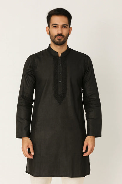 Man wearing a lucknowi chikankari  black kurta against a white background