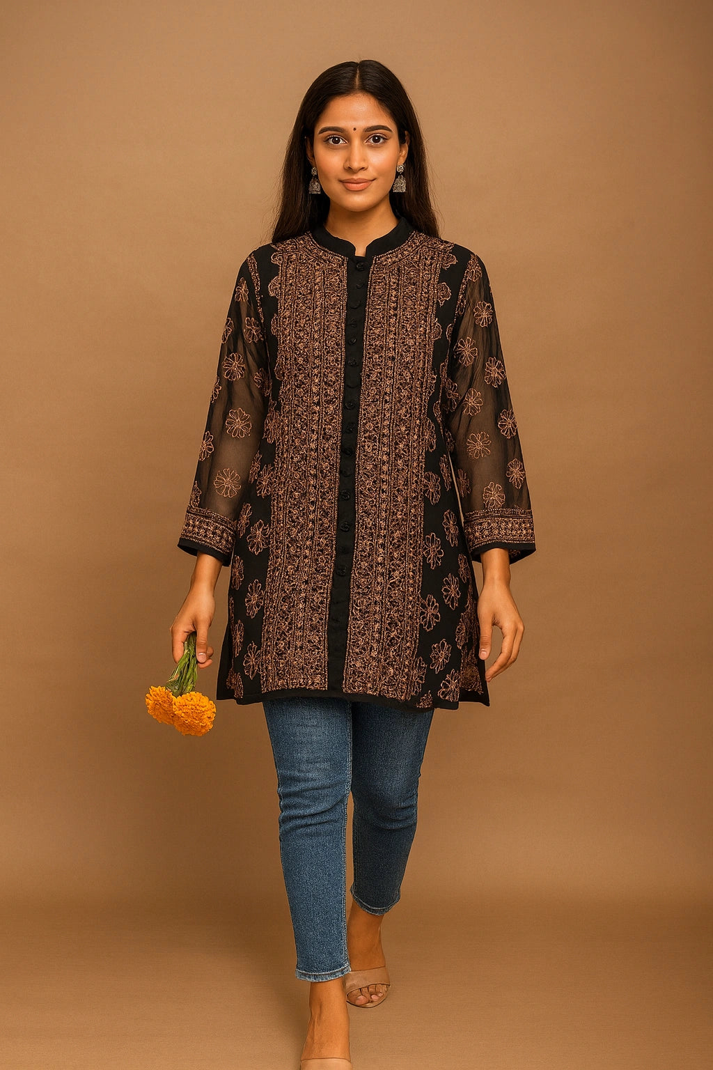 Lucknowi chikankari Woman wearing a patterned brown top and blue jeans against a brown background