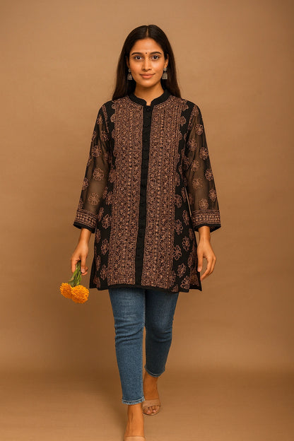 Lucknowi chikankari Woman wearing a patterned brown top and blue jeans against a brown background