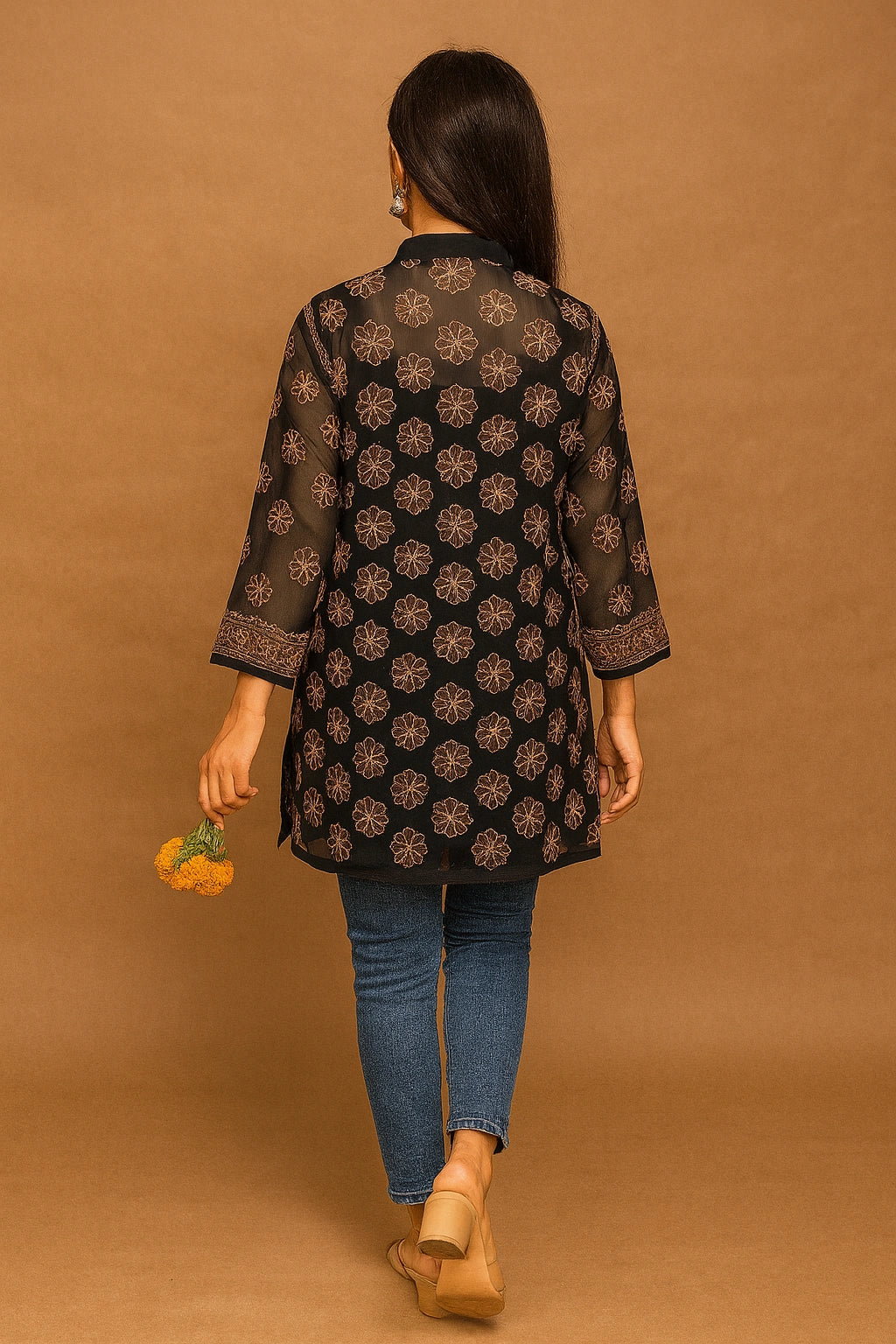 lucknowi chikankari Woman wearing a black floral patterned shirt against a brown background