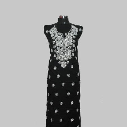Black dress with white floral embroidery on a mannequin against a gray background