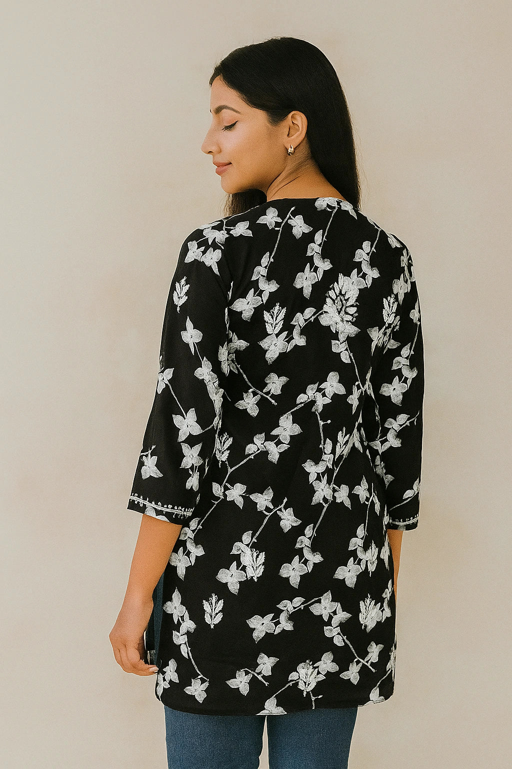 lucknowi chikankari Woman wearing a black floral patterned top against a plain background