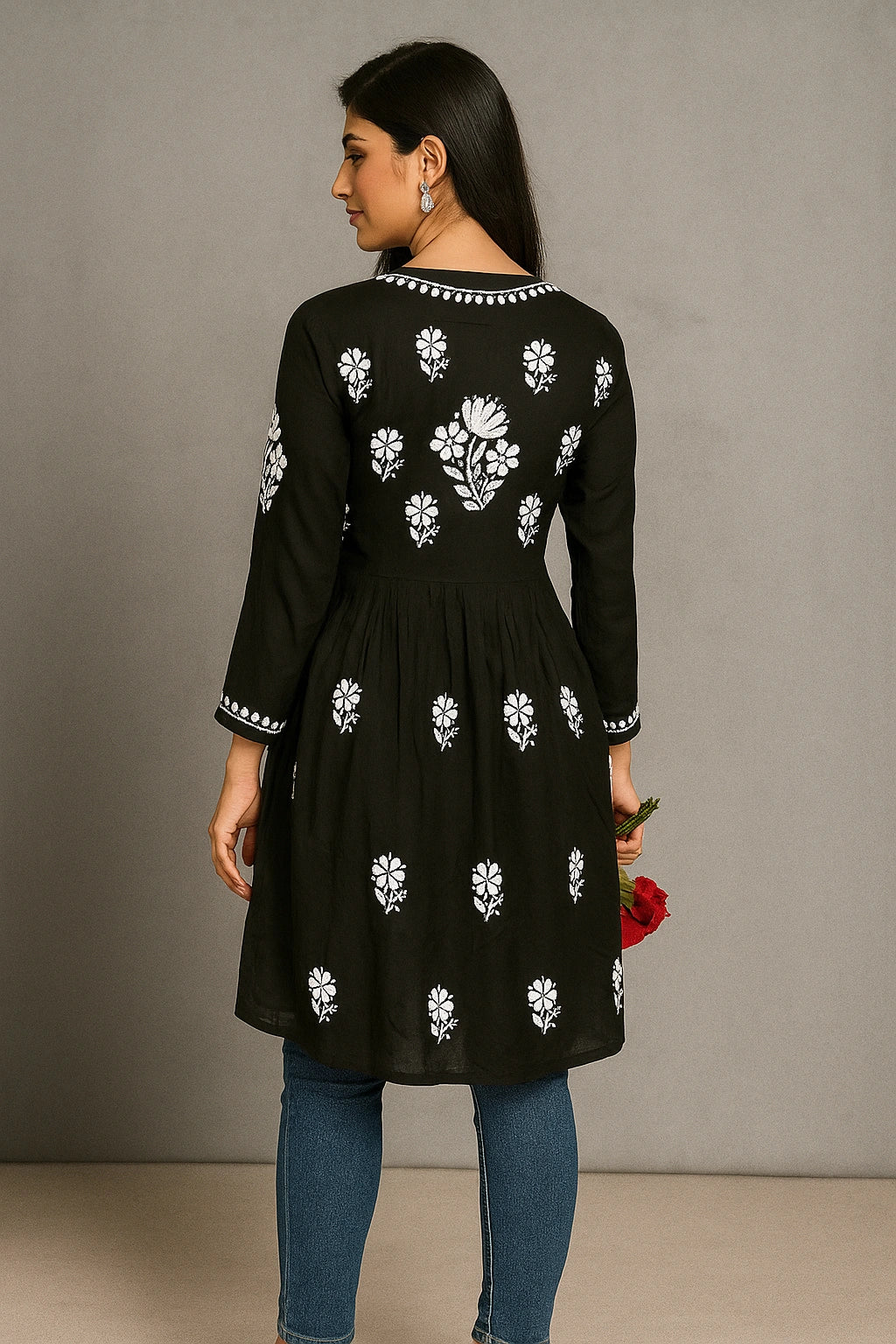 lucknowi chikankari Woman wearing a black dress with white floral patterns against a gray background